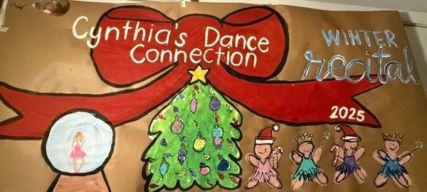 Colorful hand-painted dance recital banner with decorated Christmas tree centerpiece, ballerinas in Santa hats and tutus, a snow globe with dancer, and red ribbon flowing across with studio name in elegant script